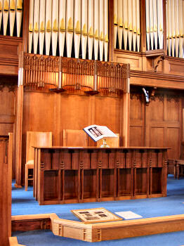 The communion table with the organ and organ screen behind Picture of the chancel with the organ