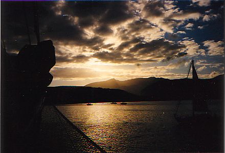 Picture of a sunset over a bay surrounded by hills