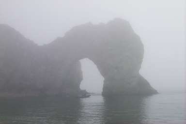 Picture of a natural arch in the fog