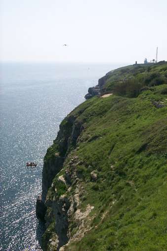 Picture of a view over a cliff, a boat below