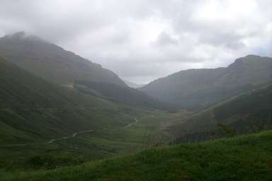 Picture of a view into a glen (valley), clouds above and rain falling