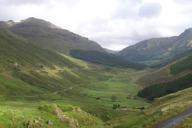 Picture of a view into a glen (valley), sun breaking through