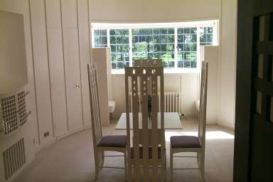 Picture of an oval shaped room with white furniture and decor