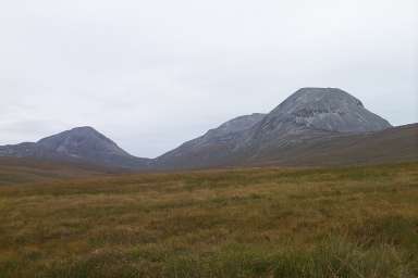 Picture of three grey hills under a grey sky