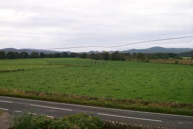 Picture of a view over a field with a stone circle