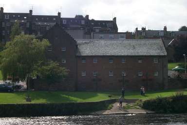 Picture of a large house, seen over a river