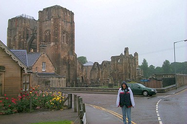 Picture of Imke standing in the rain in front of Elgin cathedral