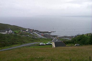 Picture of a view down to a pier, the sea behind it hidden in rain and cloud