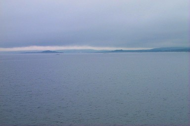 Picture of land appearing in the haze seen from a ferry