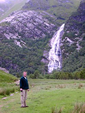 Picture of Armin in the glen with a waterfall behind him