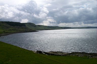 Picture of a view over the bay at Duntulm Castle, sun breaking through and reflecting on the water