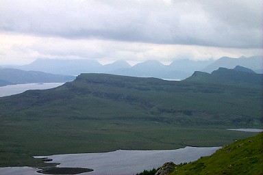 Picture of a view towards Portree from the Old Man of Storr, low clouds above