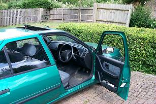 Picture of a car with an open sunroof and open door