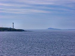 Picture of Rhuvaal lighthouse with Colonsay in the background