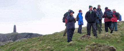 Picture of walkers with the American Monument in the background