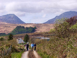 Picture of walkers with the Paps of Jura in the background