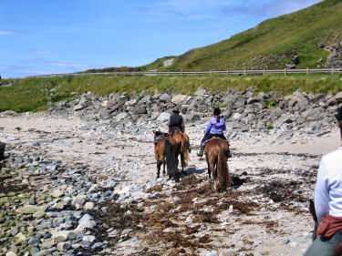 Picture of riders riding along the shore