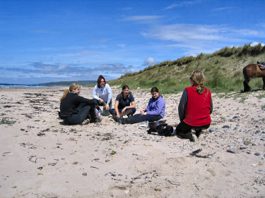 Picture of riders having a picnic on the beach