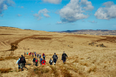 Picture of walkers heading into the hills of Jura
