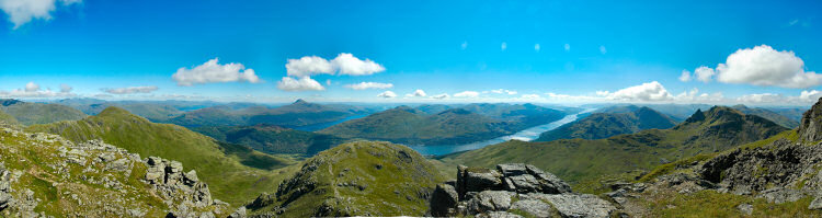 Picture of a panoramic view over mountains and lochs from the summit of a Munro