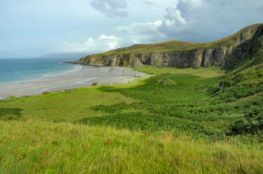 Picture of a view over a beach below some cliffs