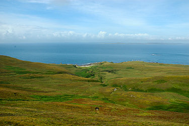 Picture of a wide plain with a shore and an island visible over the water