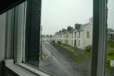 Picture of a rainy street seen through a window