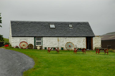 Picture of a white building with a sign pottery