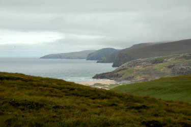 Picture of a bay becoming visible behind hills