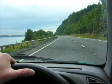 Picture of a road along a loch with cloudy skies