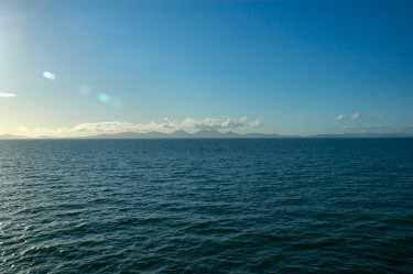 Picture of the silhouette of an island on the horizon