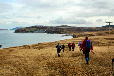 Picture of walkers approaching Bunnahabhain Bay