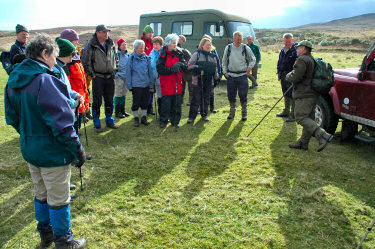 Picture of a group of walkers listening to the walk leader