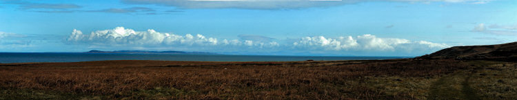 Picture of a panoramic view over a coast with an island in the distance