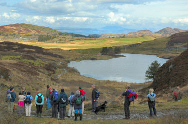 Picture of a group of walkers looking over an island landscape