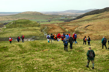 Picture of walkers approaching an old hill fort
