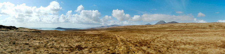 Picture of a panoramic view over a coastline with bays and some hills