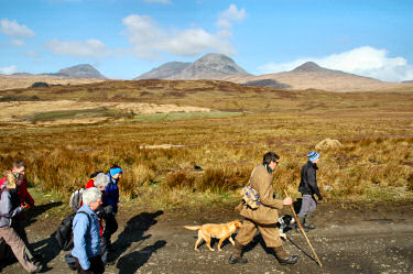 Picture of walkers with the Paps of Jura in the background