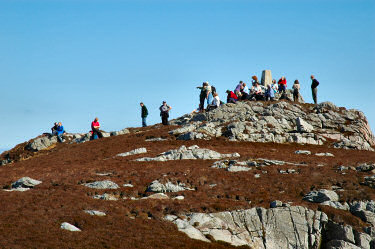 Picture of a group of people around a trig point