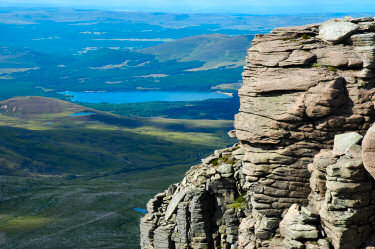 Picture of a view over a loch (lake) from high above, cliffs in the foreground