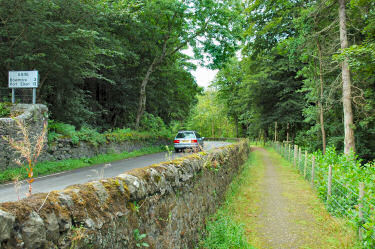 Picture of a road with a footpath separated by a wall