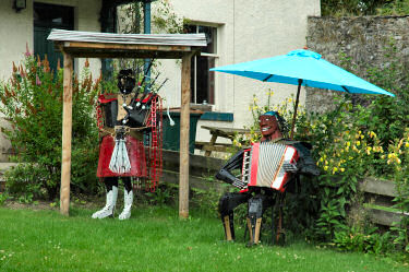 Picture of two statues of musicians in a garden