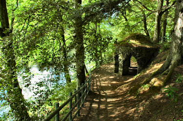 Picture of a path along a river dropping down to some kind of shelter