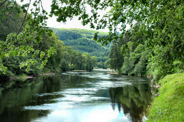 Picture of a river flowing through a wooded landscape