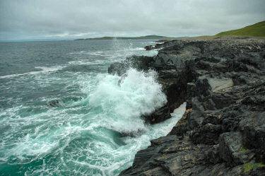 Picture of a wave coming in over low cliffs