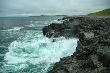 Picture of the water running off after a wave broke over low cliffs