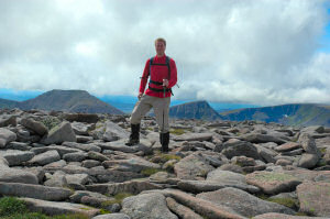 Picture of a walker on a hill, other hills in the background