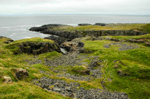 Picture of a shoreline with a disused slate quarry