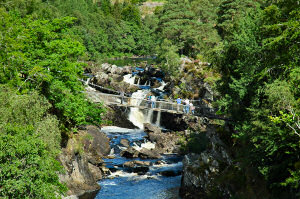 Picture of a waterfall, a bridge crossing the river in front of it