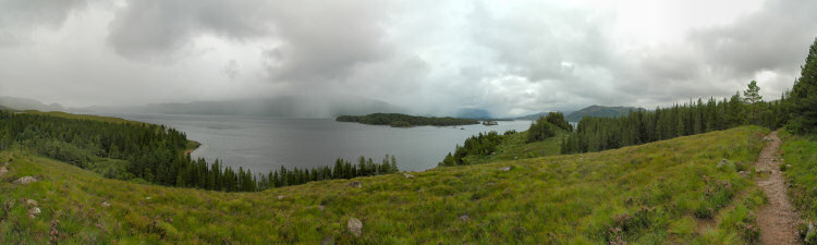Picture of a panoramic view over a loch (lake), rain in the distance